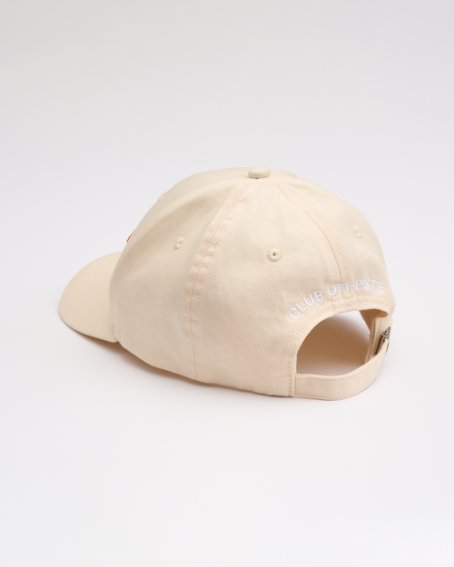Beige cap with "Club Off Piste" written on it