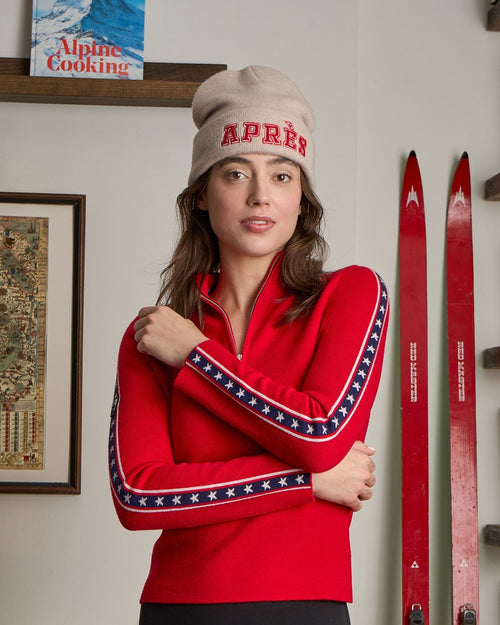 woman wearing red ski sweater with stars and stripes on the sleeves in merino wool